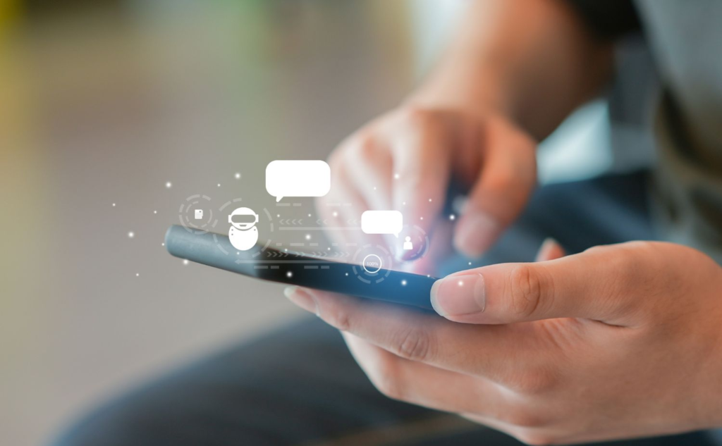 Person texting on smartphone with chat icons